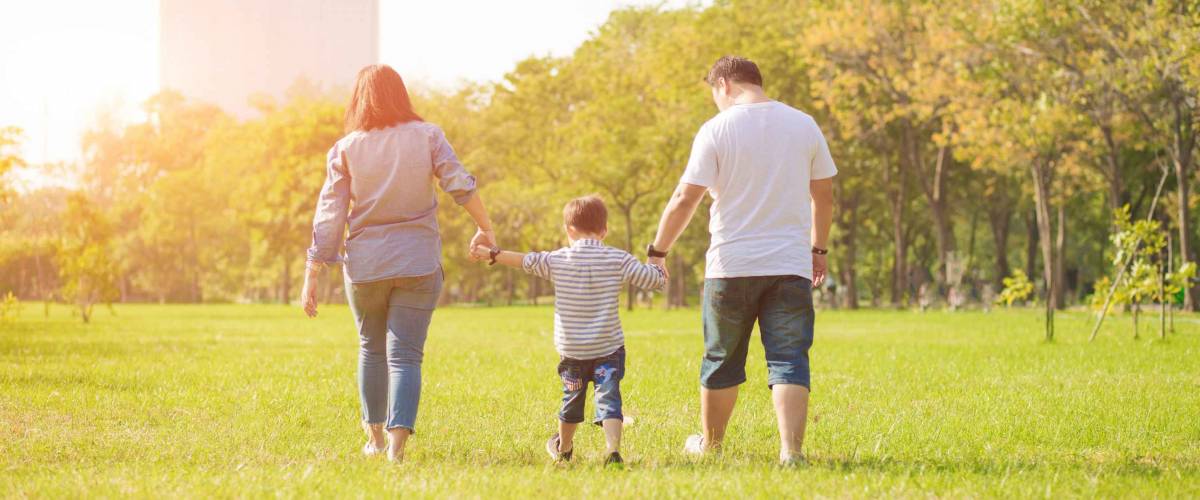 Mother playing with son  in the field. Happy family life style concept.