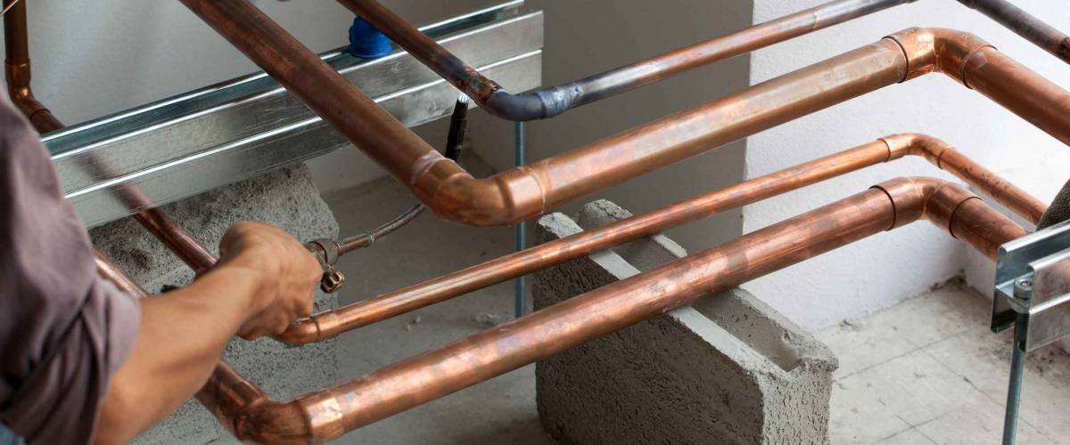 HVAC technician soldering a copper joint for Air Conditioning