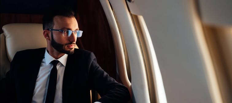 Young wealthy professional on a private jet