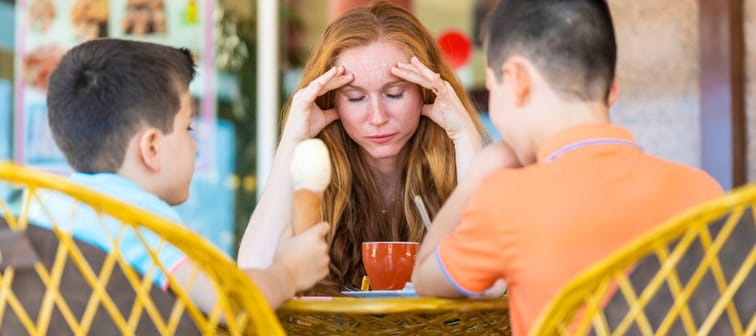 Stressed mum out with her two young boys