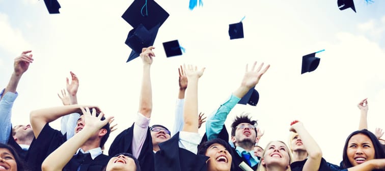 Graduating students throwing caps in the air