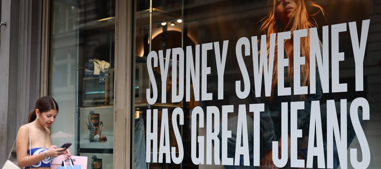 Girl walking past American Eagle store
