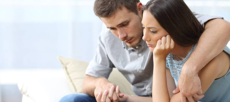 Man consoling woman
