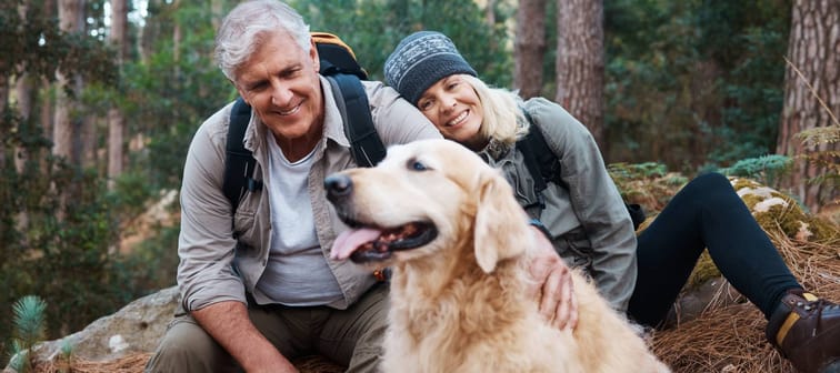 Older couple with dog in woods