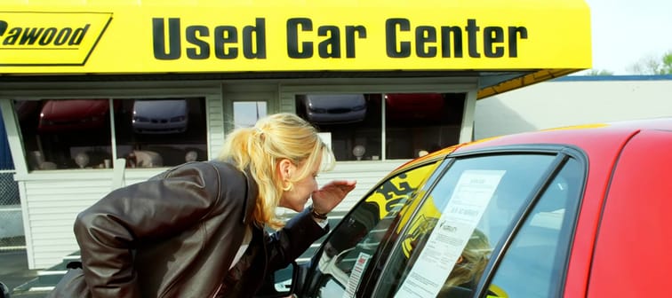 Young woman shops for a used automobile. April 20, 2023