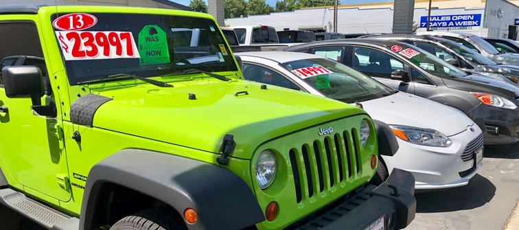 Woodland, CA - June 10, 2019: Used car dealership outside lot with sale discount tags on used American automobiles.