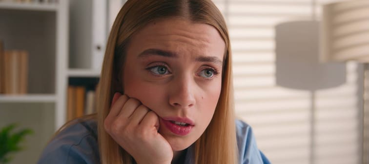 Tired and worried younger woman