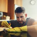 Middle-aged man cleaning kitchen counter