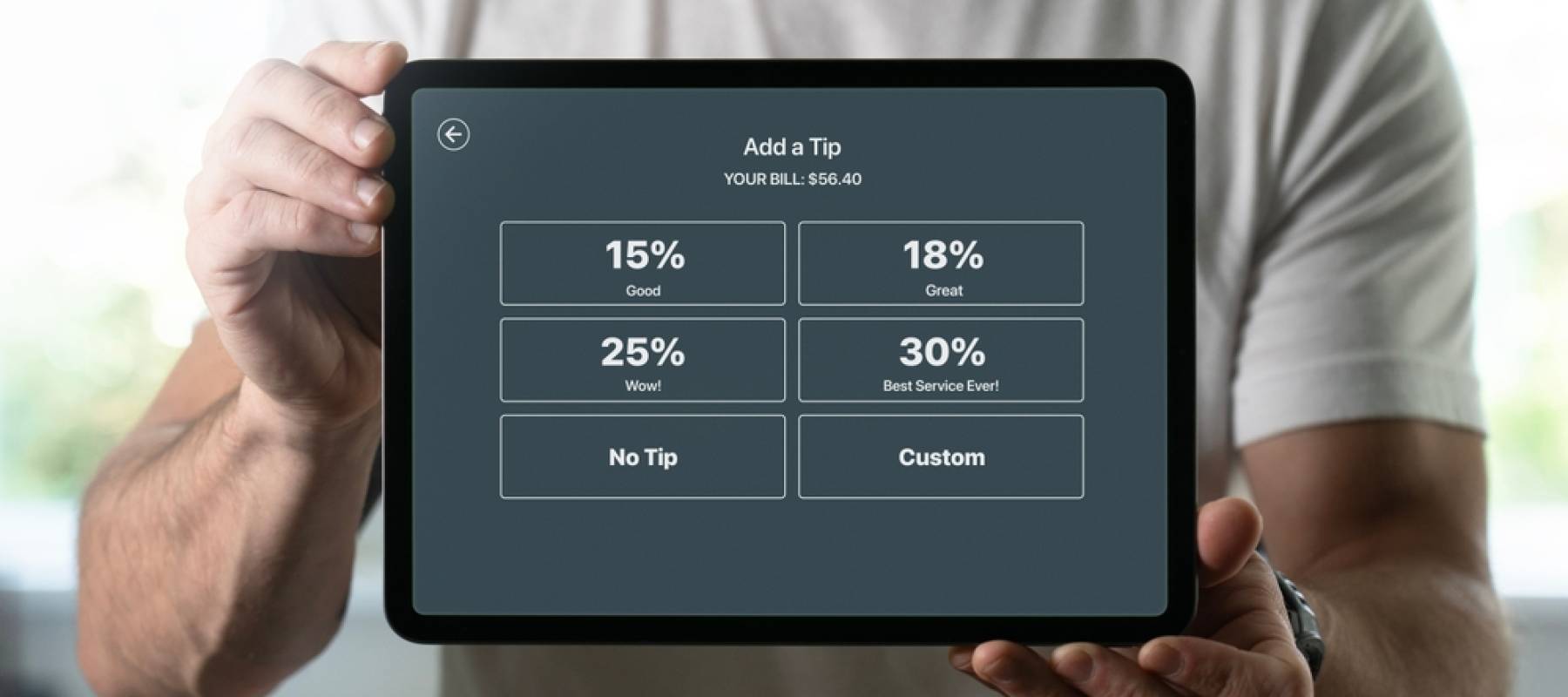 Man holding a tablet with tipping screen