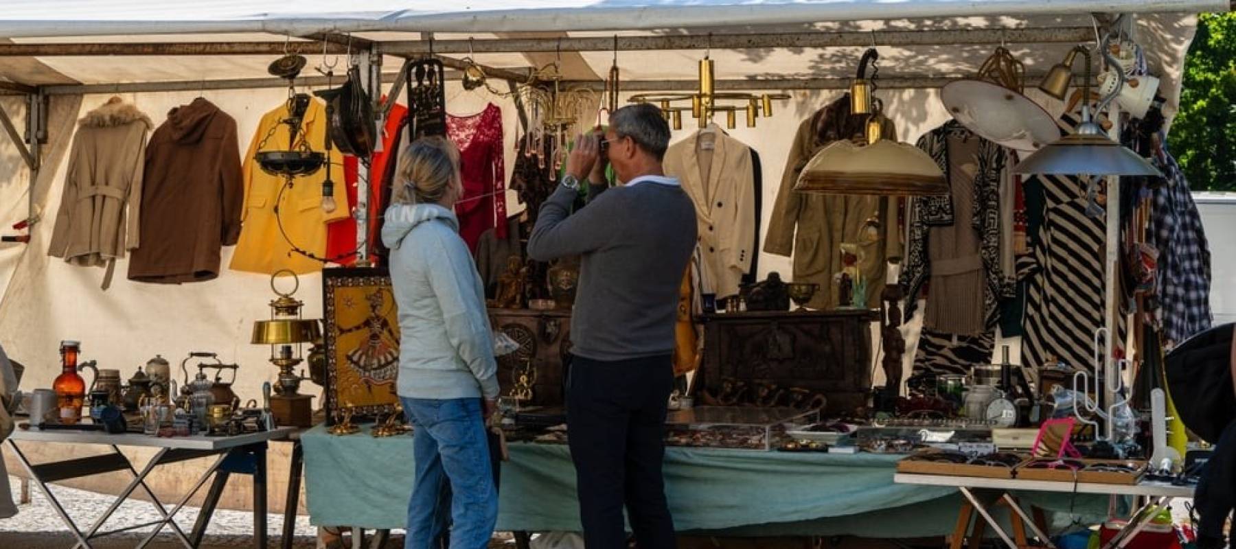 A senior couple at a flea market stand.