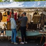 A senior couple at a flea market stand.