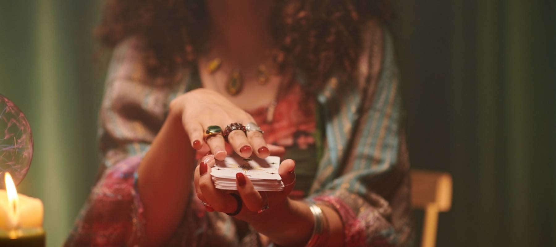 Hands of psychic shuffling tarot cards