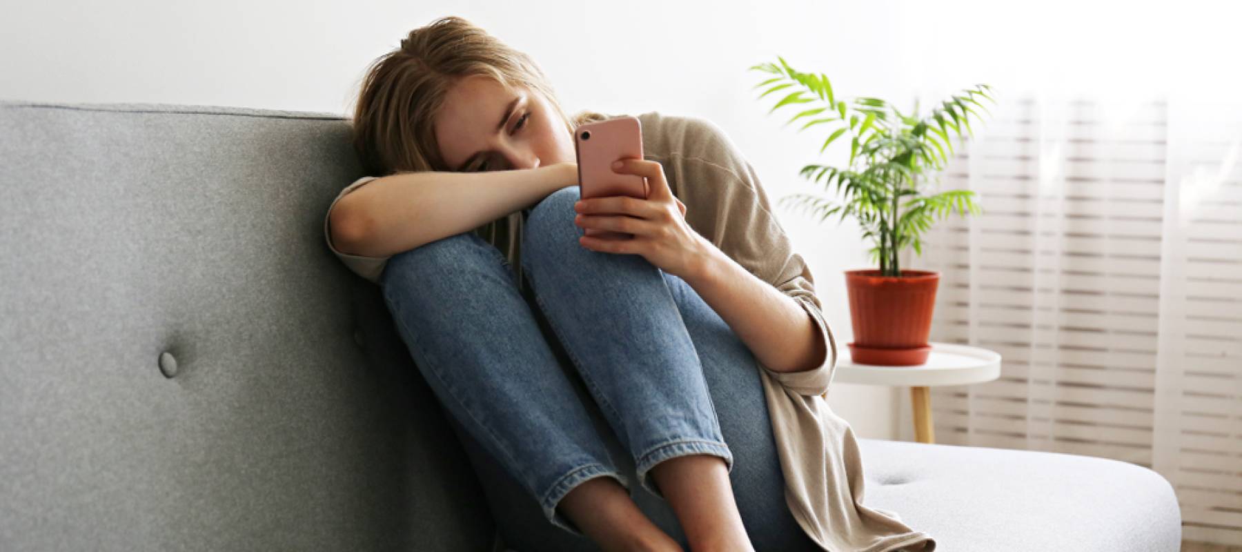 Woman on phone looking sad