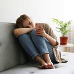 Woman on phone looking sad