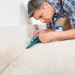 Tradesman installing carpet