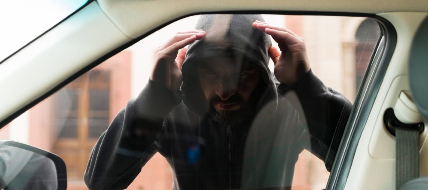 man breaking into car