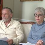 Man and woman sitting on a couch on camera.