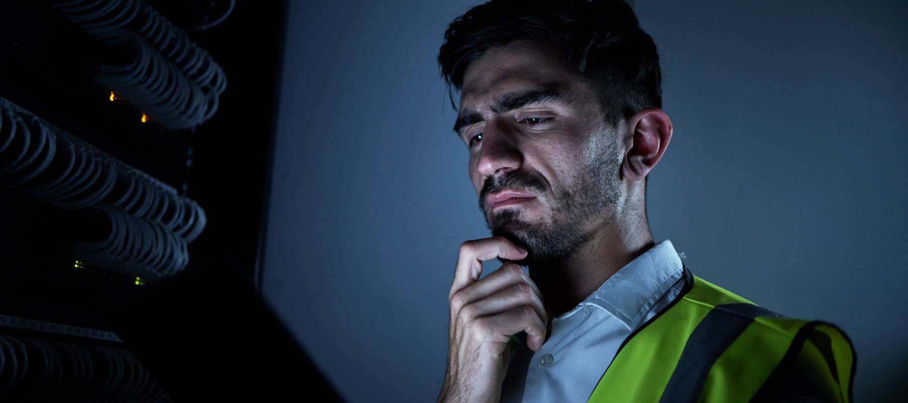 Man in safety vest looking pensive