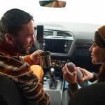 Young couple in front seat of car