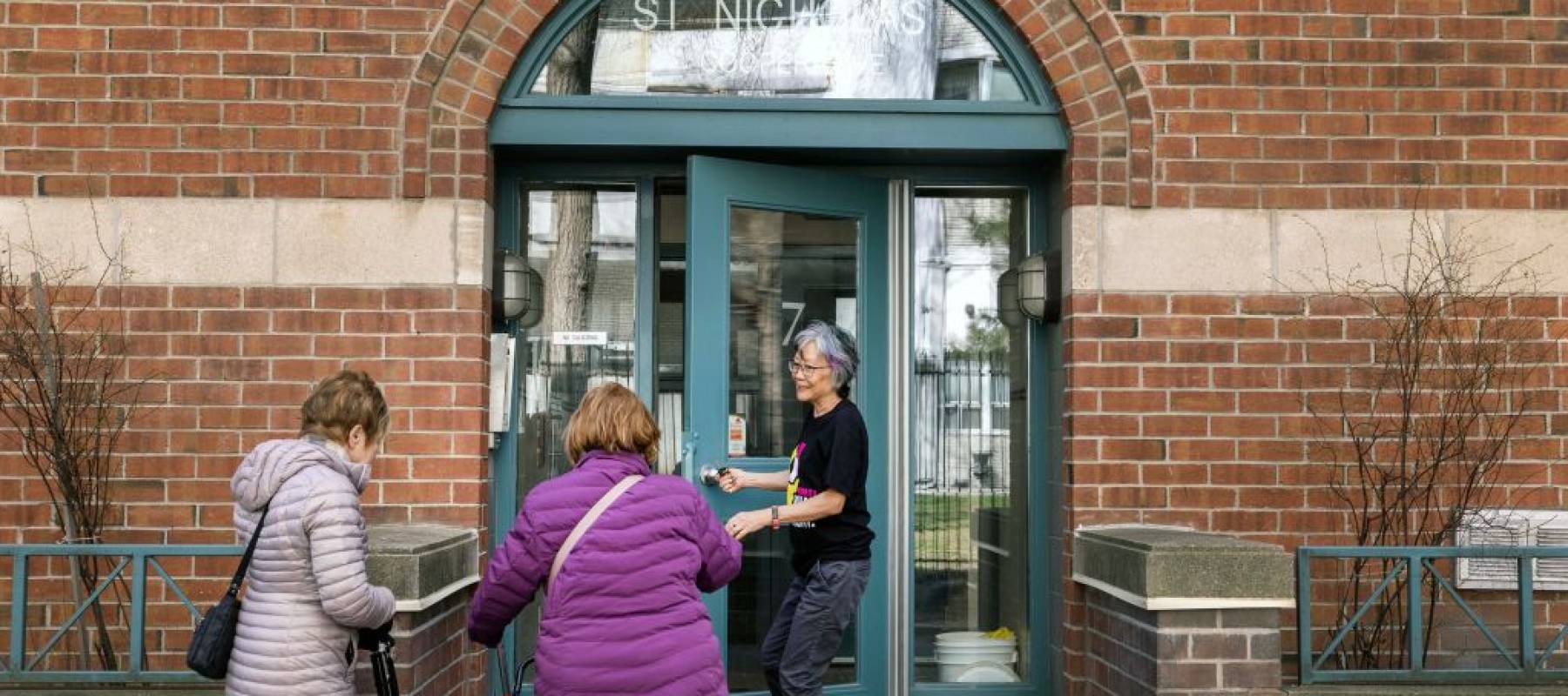 - Dawn Obokata holds a door for tenants outside her co-op apartment in Toronto