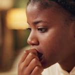 Young black woman looking stressed (over debt)