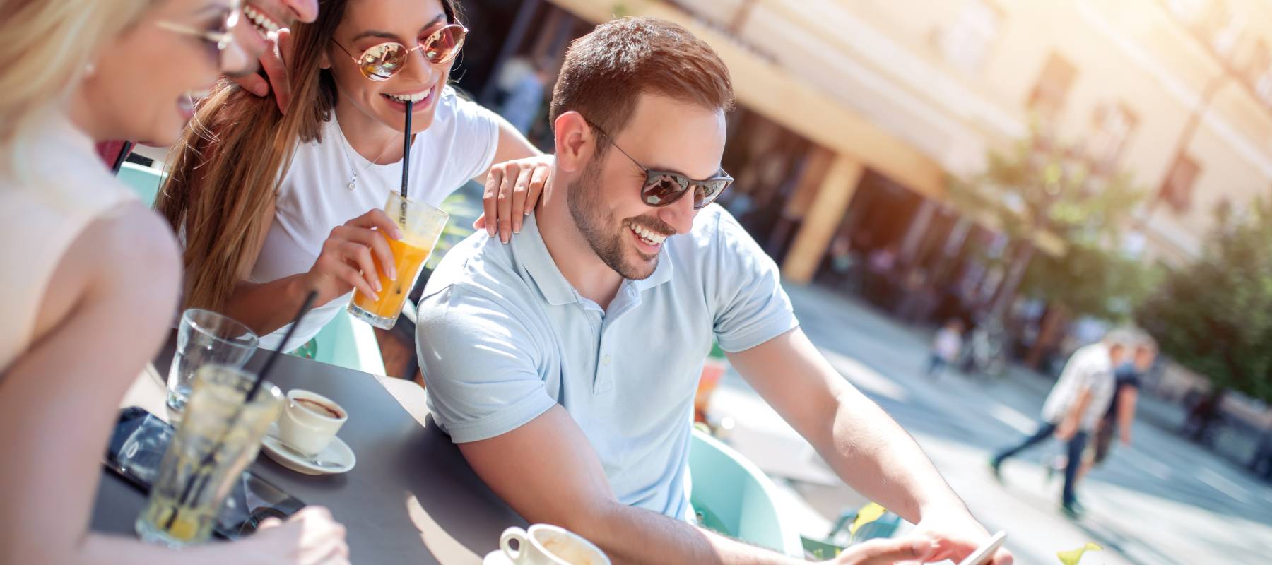 Cheerful group of friends having fun in cafe, taking selfie.