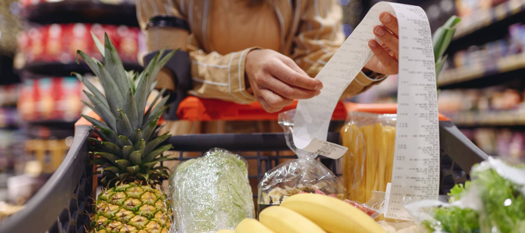 Young woman looks over a grocery receipt