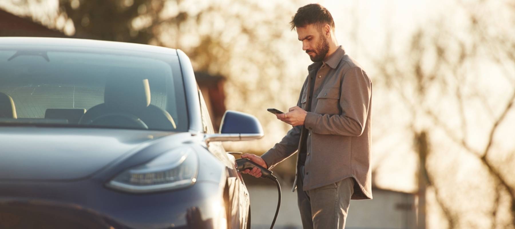 Man charging his electric vehicle (EV)