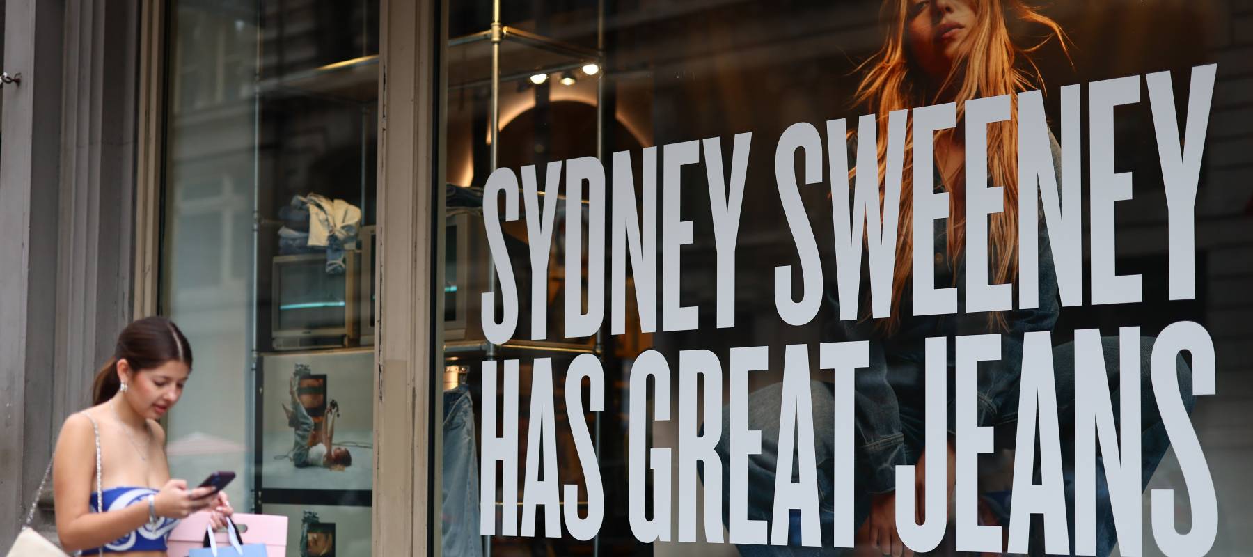 Girl walking past American Eagle store