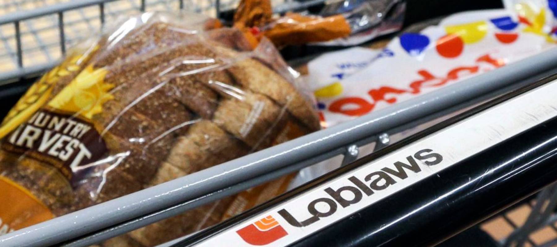 Two brands of bread are shown in a Loblaws shopping cart
