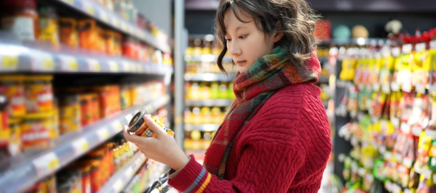 Woman checking prices in the grocery store