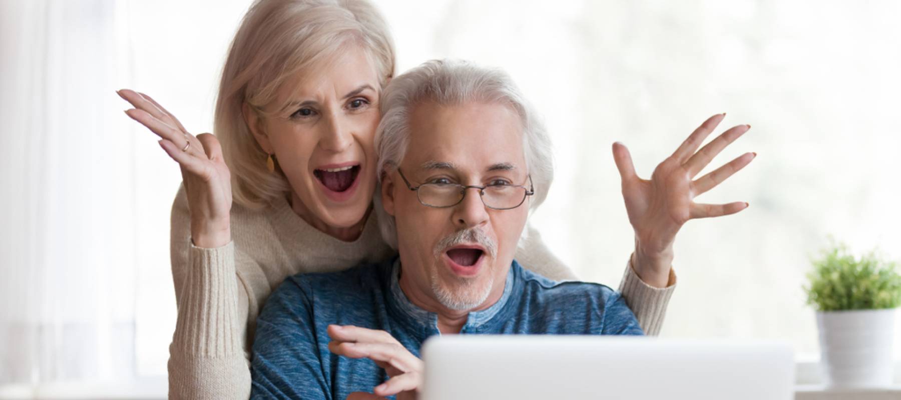 Couple looking shocked on computer
