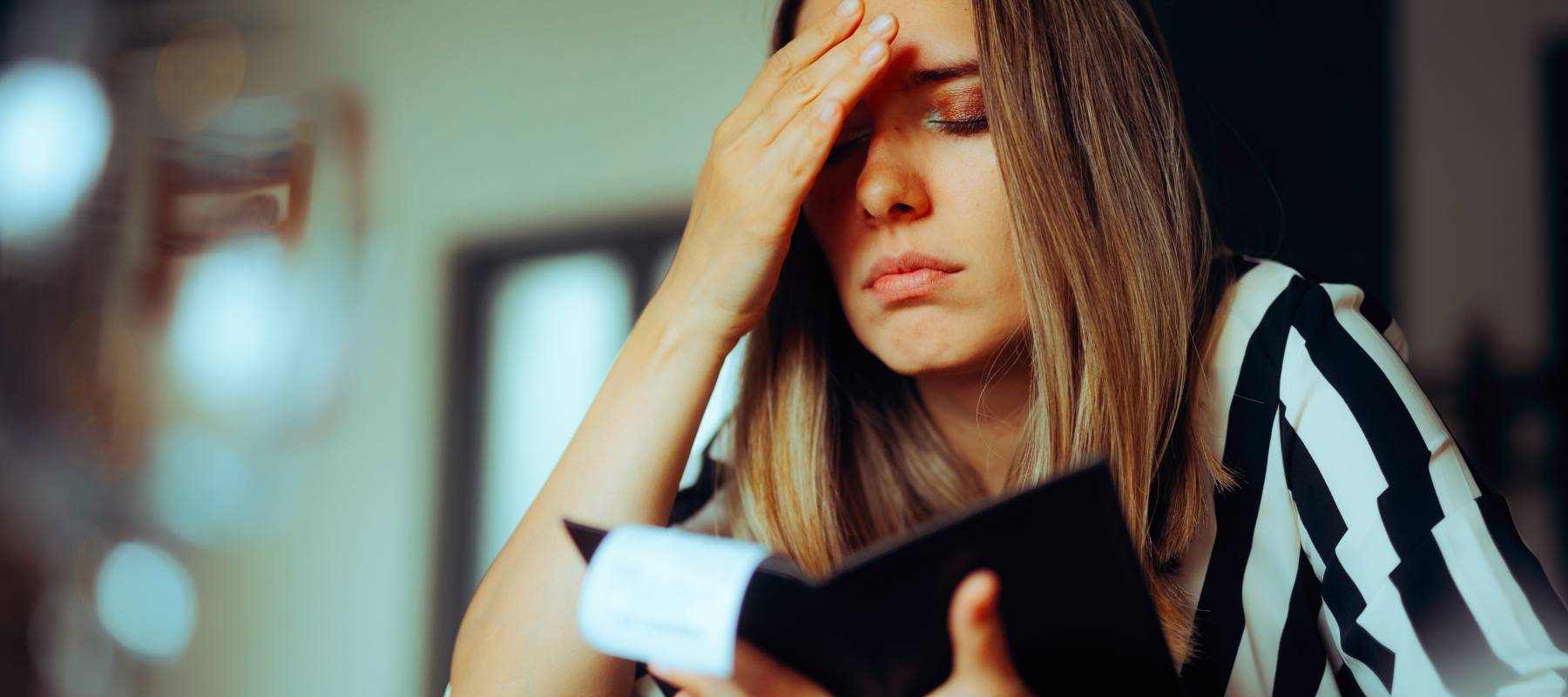 Unhappy Woman Receiving an Overpriced Bill in a Restaurant.