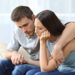 Man consoling woman