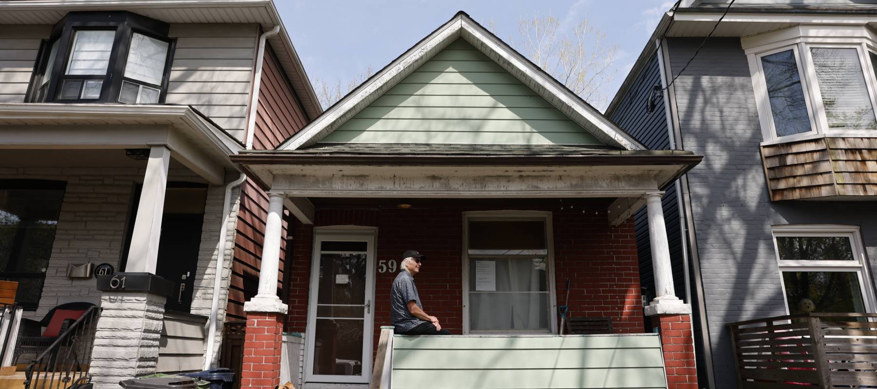Donald MacPherson poses for a photo in front of the house he inherited from his uncle.