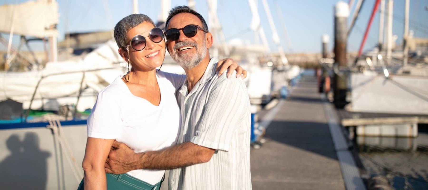 Older couple smiling at marina