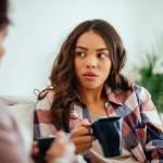 Young woman talking to older woman.