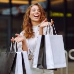 Woman smiling with many shopping bags