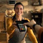 Woman holding payment machine