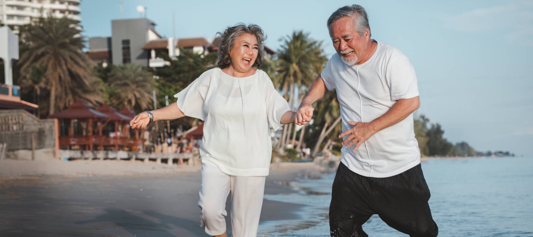 Older couple running on beach