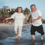 Older couple running on beach