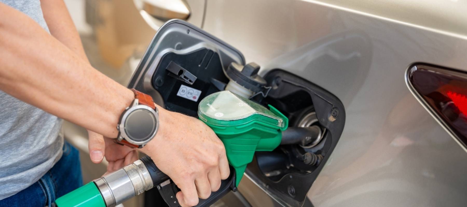 Close up of man filling car with gas