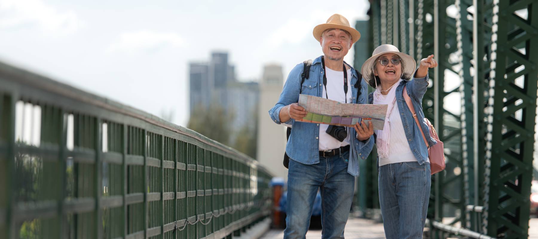 Elderly couples travel on the old iron bridge (Phra Phutthayotfa Bridge) in Bangkok, Thailand