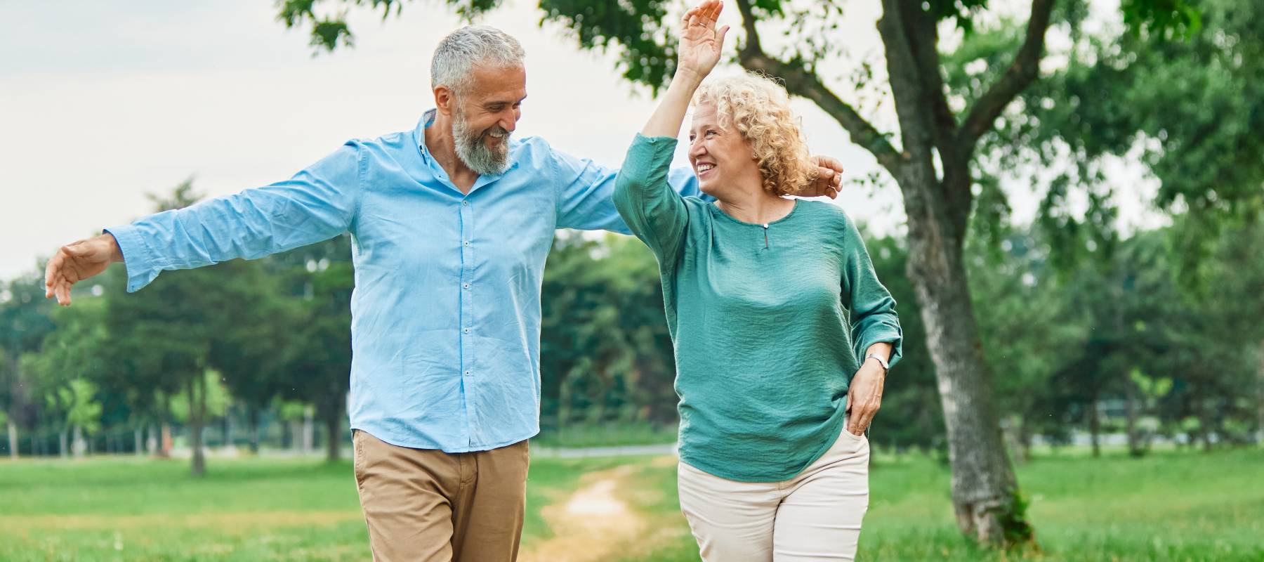 Happy older couple walking outside