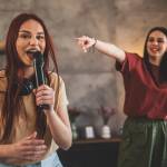 Young women doing karaoke