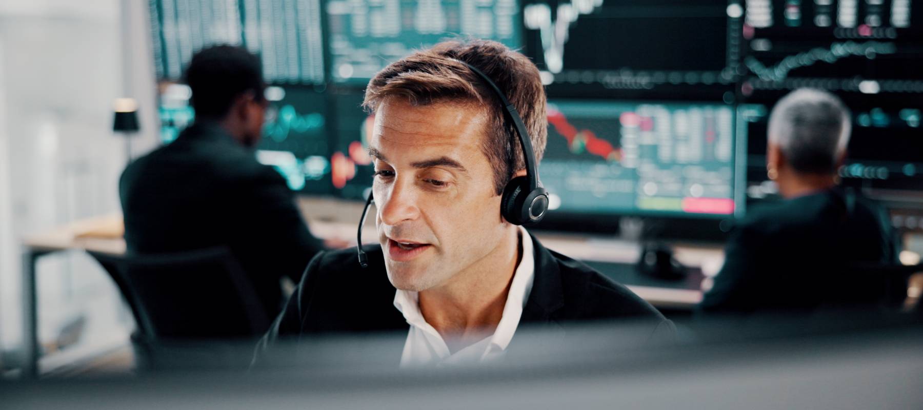 Man sitting at a computer making equity trades