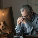 Man depressed on computer