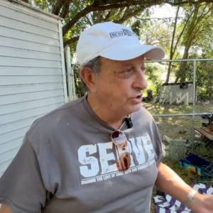 Florida landlord Tom Luby speaking to reporters outside his rental home.