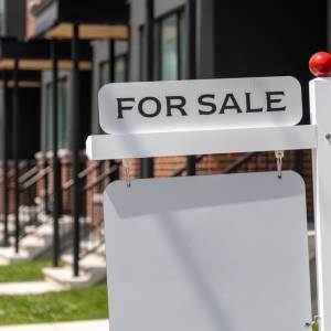 For sale sign in front of home
