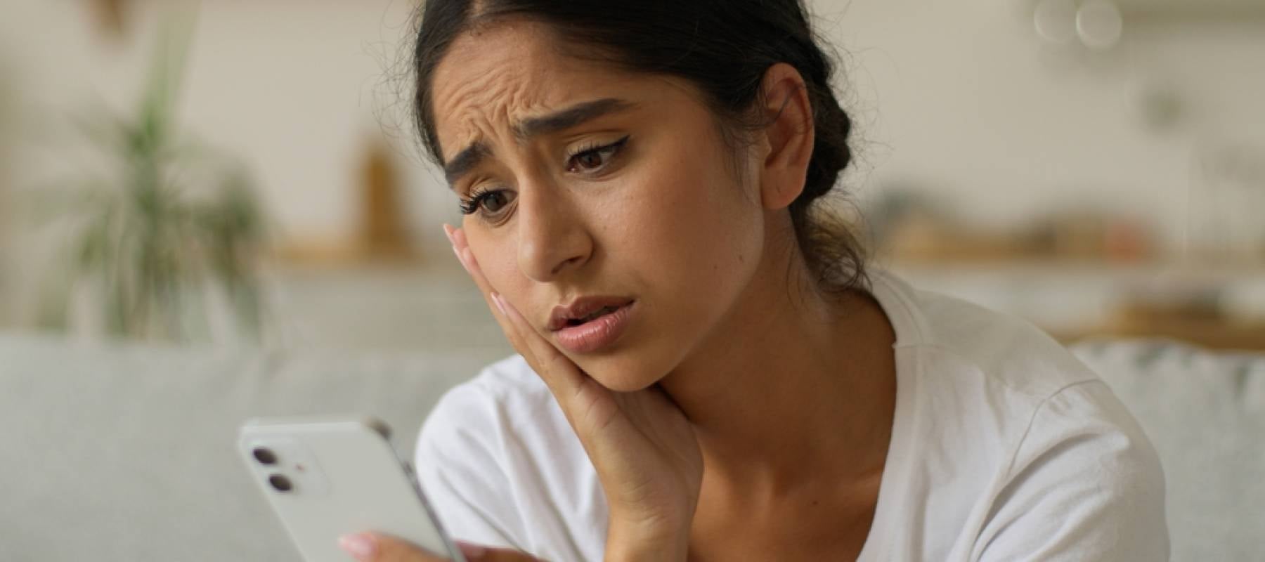 Woman looking confused on phone